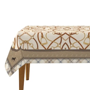 May include: A cream-colored tablecloth featuring a horse-themed design. The pattern includes brown leather straps, gold-colored chains, and stirrups. A border with a horse silhouette and plaid accents adds detail to the equestrian theme.