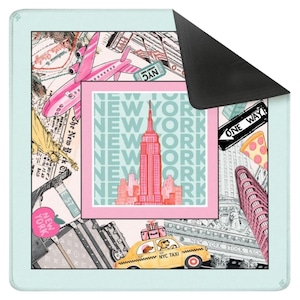 May include: A rectangular mousepad with a New York City theme. The design features the Empire State Building, a pink airplane, a yellow taxi, and the text "NEW YORK". The border is light blue.