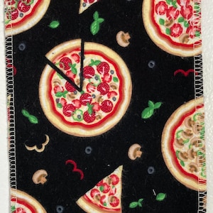 May include: Black fabric with a repeating pattern of pizza slices and whole pizzas. The pizza has red sauce, cheese, green peppers, and mushrooms.
