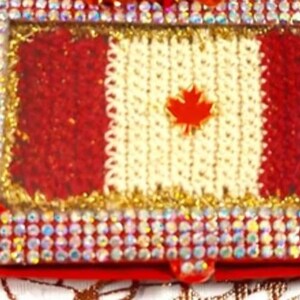 May include: A red, white, and gold Canadian flag pin patch, crocheted in miniature, framed with rhinestones and a ladybug charm. The text "MICRO-Crochet Canadian Flag Pin Patch" is displayed above the pin.