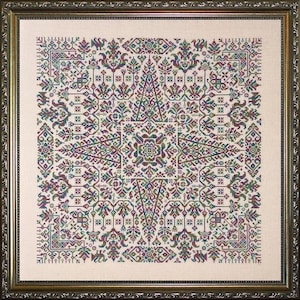 May include: A framed cross-stitch embroidery with a geometric pattern in shades of green, red, and blue on a cream-colored background.