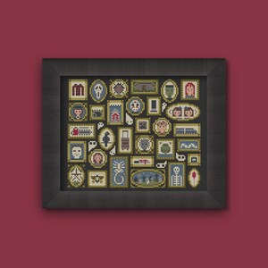 May include: A framed cross-stitch artwork featuring a collection of small, framed images with various spooky and Halloween-themed designs. The artwork is framed in a dark, rectangular frame against a dark red background.