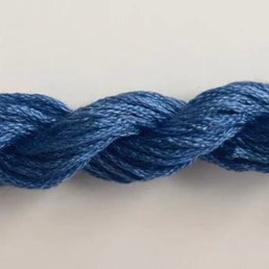 May include: A length of twisted blue embroidery floss. The floss is a medium shade of blue, with subtle variations in color. The strands are tightly twisted together, creating a rope-like appearance. The background is a plain white surface.