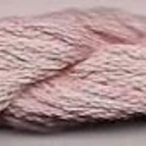 May include: A close-up of a soft, pink yarn. The yarn is twisted and textured, creating a braided effect.