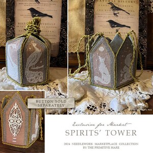 May include: A needlepoint kit for a hexagonal tower with a white and gray design featuring a bird and a cat. The kit is called "Spirits' Tower" and is part of the 2024 Needlework Marketplace Collection by The Primitive Hare.