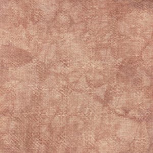 May include: Close-up of a textured fabric in a muted, dusty rose color. The weave is visible, creating a subtle pattern across the surface. The fabric appears to be a natural fiber, possibly linen or cotton, with a slightly irregular texture.