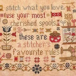May include: A cross-stitch sampler with the text "stitch what you love, use your most cherished spools, these are a stitcher's favourite rules." The design includes images of spools, scissors, and a sewing machine, all in shades of brown, red, and black.