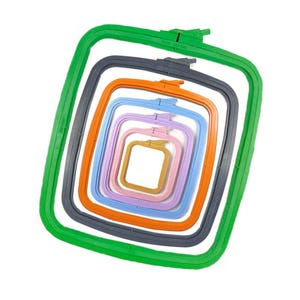 May include: A stack of colorful embroidery hoops in various sizes. The hoops are in shades of green, gray, orange, blue, lavender, and gold. Each hoop is square-shaped and made of plastic, designed for holding fabric taut during embroidery.