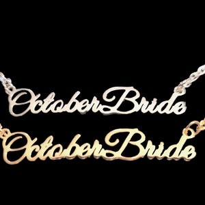 May include: Two necklaces with the words "October Bride" in a cursive script. The top necklace is silver and the bottom necklace is gold.