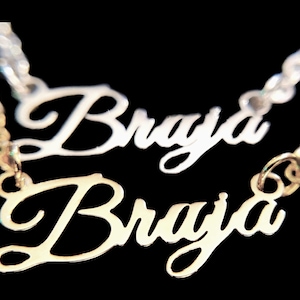 May include: Gold necklace with the name "Braja" spelled out twice in cursive script.