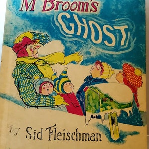 May include: A vintage children's book cover with a blue background and the title "Mc Broom's Ghost" in pink and white lettering. The cover features a cartoon illustration of a man with a yellow scarf and four children looking up at a ghost.