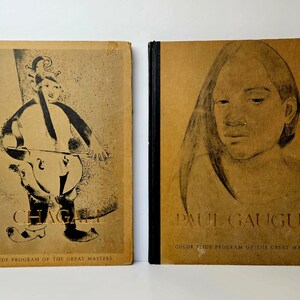 May include: Two vintage book covers featuring color slide programs of the great masters. The left cover features a black and white illustration of a musician playing a cello with the text "CHAGALL" and "COLOR SLIDE PROGRAM OF THE GREAT MASTERS". The right cover features a black and white illustration of a woman's face with the text "PAUL GAUGUIN" and "COLOR SLIDE PROGRAM OF THE GREAT MASTERS".