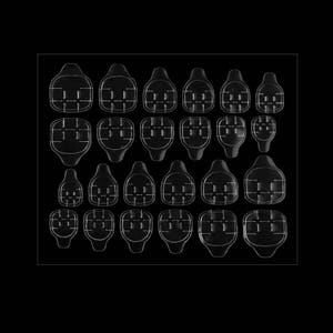 May include: A collection of twenty-four clear, adhesive nail tabs arranged in four rows on a rectangular sheet. Each tab features a rounded, shield-like shape with a distinct grid pattern embossed on the surface for secure application.