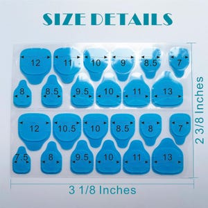 May include: A sheet of blue adhesive nail tabs featuring various sizes labelled with numbers from 7 to 13. The sheet includes text reading SIZE DETAILS and dimensions of 7.94 cm by 6.03 cm, with arrows indicating the width of each individual tab.