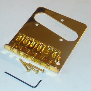 May include: Gold-plated guitar bridge with six saddles and a mounting plate. The bridge is designed for a six-string electric guitar. It includes mounting screws and an Allen wrench.