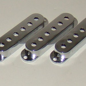 May include: Three chrome-plated guitar pickup covers with six holes each.