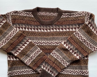 May include: A brown and white patterned sweater with a crew neck.