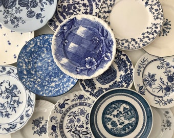 May include: A collection of blue and white patterned ceramic plates. The plates feature various floral and geometric designs.