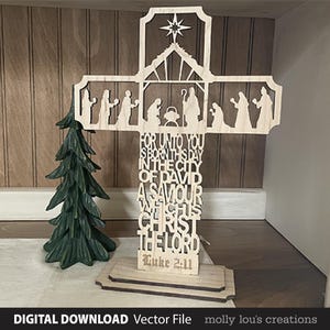 May include: A wooden cross with a nativity scene cutout and the text "For unto you is born this day in the city of David a Saviour which is Christ the Lord Luke 2:11".