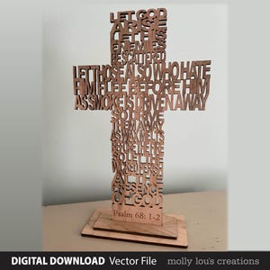 May include: A wooden cross featuring carved text from Psalm 68:1-2. The brown cross stands on a rectangular base. The text includes phrases such as "Let God arise" and "Let those also who hate Him flee."