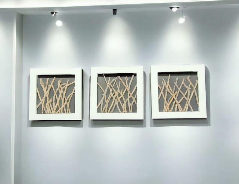 May include: Three white framed wall art pieces with a gray background and a design of natural driftwood branches.