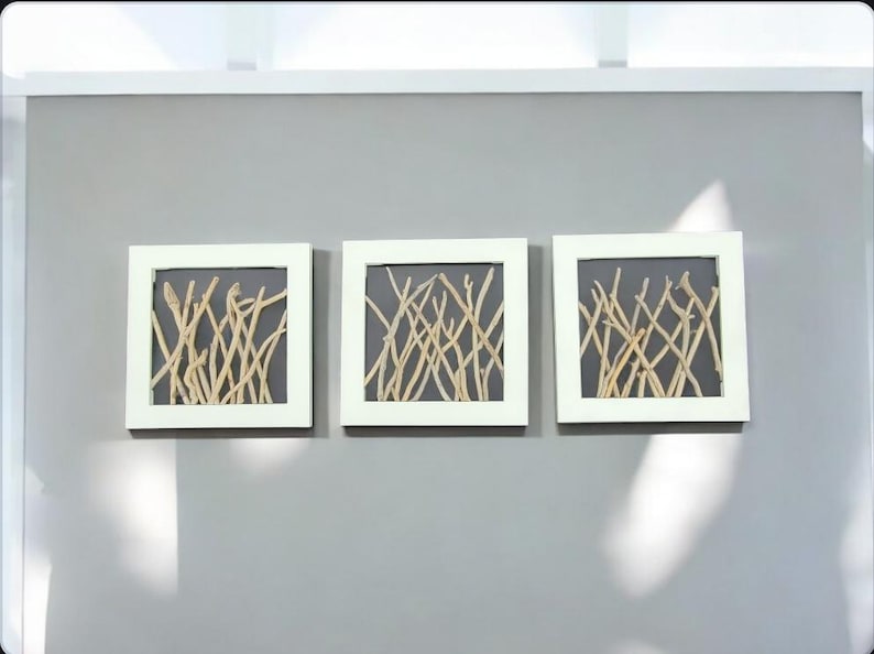 May include: Three white framed square wall art pieces with a gray background and a pattern of light brown twigs.