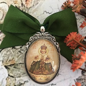 Holy Infant Jesus of Prague. Brooches. Saint Romero, let the bad go out and the good come in.