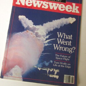 May include: Newsweek magazine cover from February 10, 1986, featuring a photo of the space shuttle Challenger exploding in the sky. The headline reads "What Went Wrong?" and the subheading reads "The Future of Space Flight".