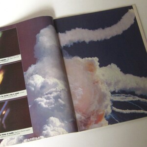 May include: A close-up image of a magazine page showing a photograph of the Challenger space shuttle exploding in a cloud of smoke. The image is accompanied by text describing the events leading up to the explosion.