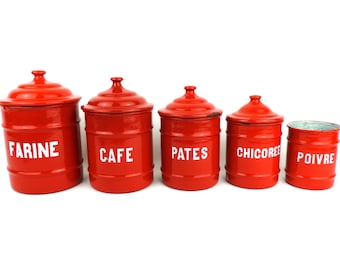 May include: Set of five red enamel canisters with white lettering. The canisters are labeled "Farine", "Cafe", "Pates", "Chicoree", and "Poivre".