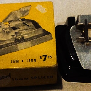 May include: A black and silver film splicer with a yellow box. The box says "Hollywood Automat Splicer" and "8mm 16mm $7.95".