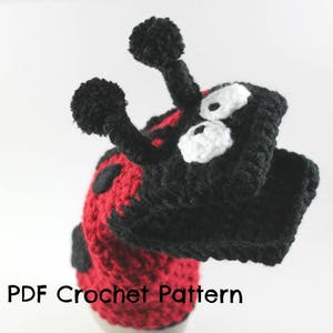 May include: Crochet pattern for a ladybug puppet. The puppet has a red body with black spots and black yarn for the head and legs. The eyes are white with black pupils.
