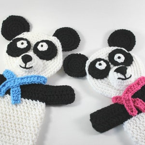 May include: Two crocheted panda puppets with black and white fur. One panda has a blue scarf and the other has a pink scarf.