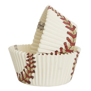 May include: Two white cupcake liners with a baseball design. The liners have a pleated texture and feature red stitching details, mimicking the look of a baseball. The design is printed on the outside of the liners.