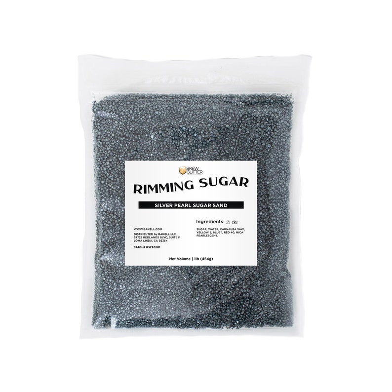 May include: A clear plastic bag containing silver pearl sugar sand for rimming cocktails. The bag features a label that reads "Rimming Sugar" and "Silver Pearl Sugar Sand". The label also lists the ingredients: sugar, water, carnauba wax, yellow 5 lake, blue 1 lake, red 40 lake, and mica pearlescent. The net volume is 1 lb (454g).