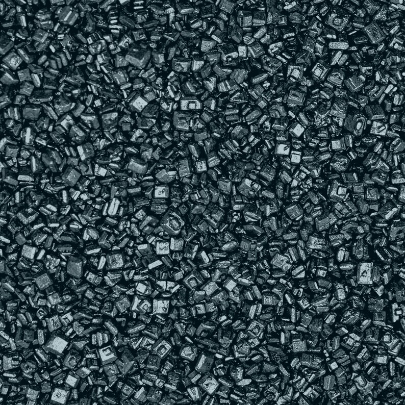 May include: A close-up image of black sugar crystals. The sugar crystals are small and have a shiny, metallic appearance.