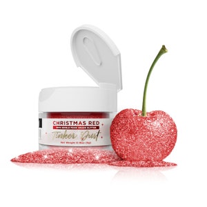 May include: A small jar of red edible glitter labeled "Christmas Red" and "Tinker Dust" with a net weight of 0.18oz (5g). A red glitter cherry is next to the jar.