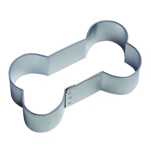 May include: A silver metal cookie cutter shaped like a dog bone.