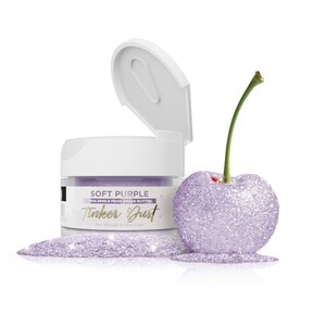 May include: A small jar of soft purple edible glitter labeled "Tinker Dust" with a cherry dusted with the glitter. The jar is 100% edible food grade glitter and has a net weight of 0.18oz (5g).