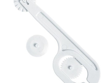 May include: White plastic pastry cutter with a wheel for cutting and a smaller wheel for making decorative edges.