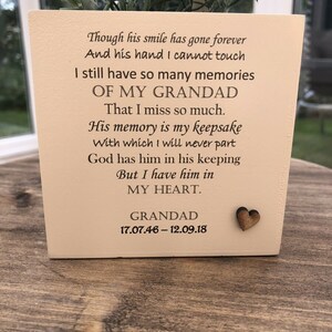 May include: A cream-colored square planter with a wooden heart accent and text that reads "Though his smile has gone forever... I have him in MY HEART." The planter contains greenery and is placed on a wooden surface.