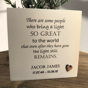 May include: Cream-colored square planter with the text "There are some people who bring a light SO GREAT to the world that even after they have gone the light still REMAINS." Includes a wooden heart and the name JACOB JAMES with dates.