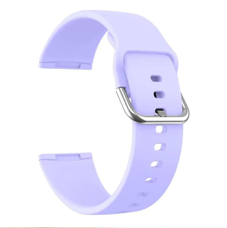 May include: A lavender silicone watch band with a silver buckle. The band has multiple holes for adjusting the fit.