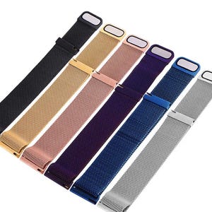 May include: A set of seven metal watch bands in various colors, including black, gold, rose gold, purple, blue, and silver. The bands are made of a fine mesh material and have a clasp closure.