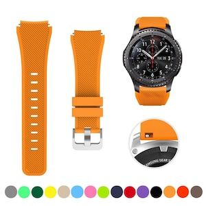 May include: A black smartwatch with a round face and an orange silicone strap featuring a diagonal ribbed texture. The set includes two separate strap pieces and a circular inset showing the attachment mechanism, plus a row of color swatches.
