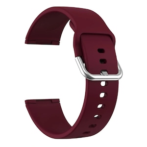 May include: A burgundy silicone watch band with a silver buckle. The band has multiple holes for adjusting the fit.