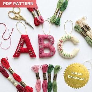 May include: A craft image featuring felt letters A, B, and C, each adorned with floral embroidery. Embroidery floss in various colors, gold scissors, and a needle are also present. The words "PDF PATTERN" and "Instant Download" are visible.