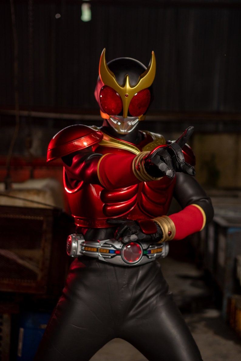 May include: A red and black action figure in a dynamic pose. The figure has a helmet with red eyes and a gold crest, a red chest plate, and black pants. The figure is wearing a silver belt with a red center.