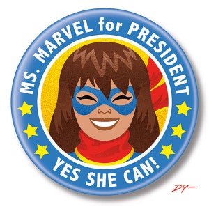 May include: A round blue button with the text "MS. MARVEL for PRESIDENT" and "YES SHE CAN!". The button features a smiling cartoon of Ms. Marvel wearing a blue mask and red scarf, with a yellow background and yellow stars.