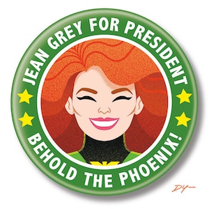 May include: A green button with the text "JEAN GREY FOR PRESIDENT BEHOLD THE PHOENIX!" in white. A cartoon image of Jean Grey with red hair is in the center of the button.